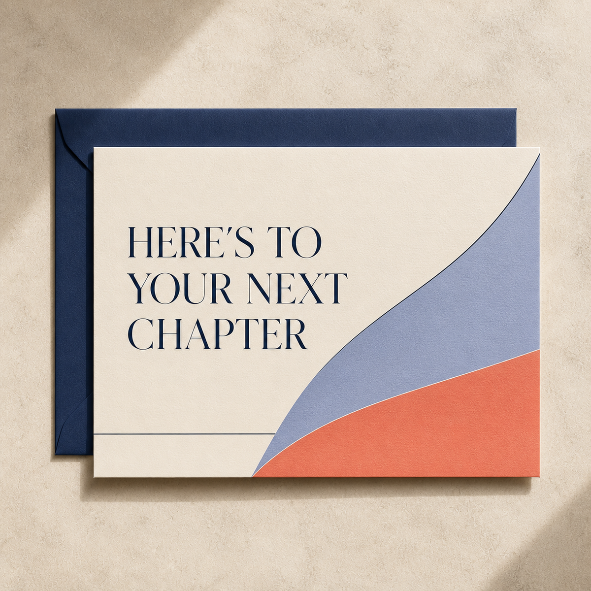 Here’s to Your Next Chapter birthday card styled with a navy envelope